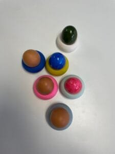 Bunte Ostereier in handgefertigten Jesmonite-Eierbechern auf Weiß - Studio.Elise Workshop für Terrazzo & DIY-Deko.